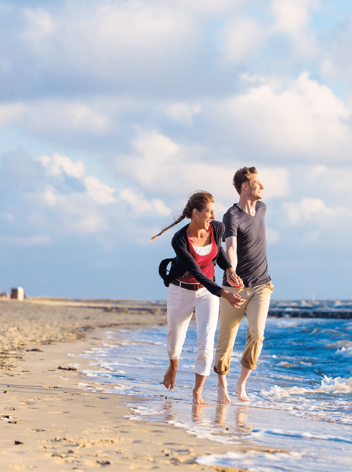 Couple enjoying romantic sunset at German north sea beach